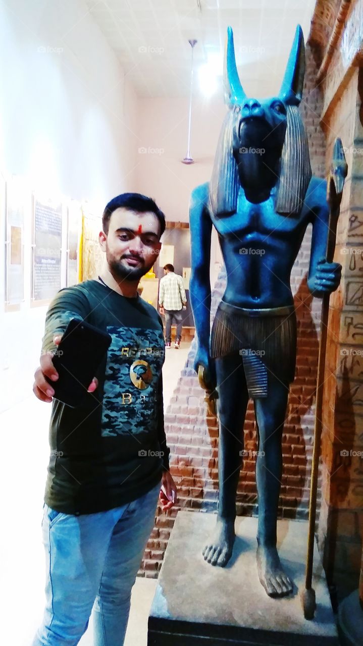 statue of goat man with boy in museum