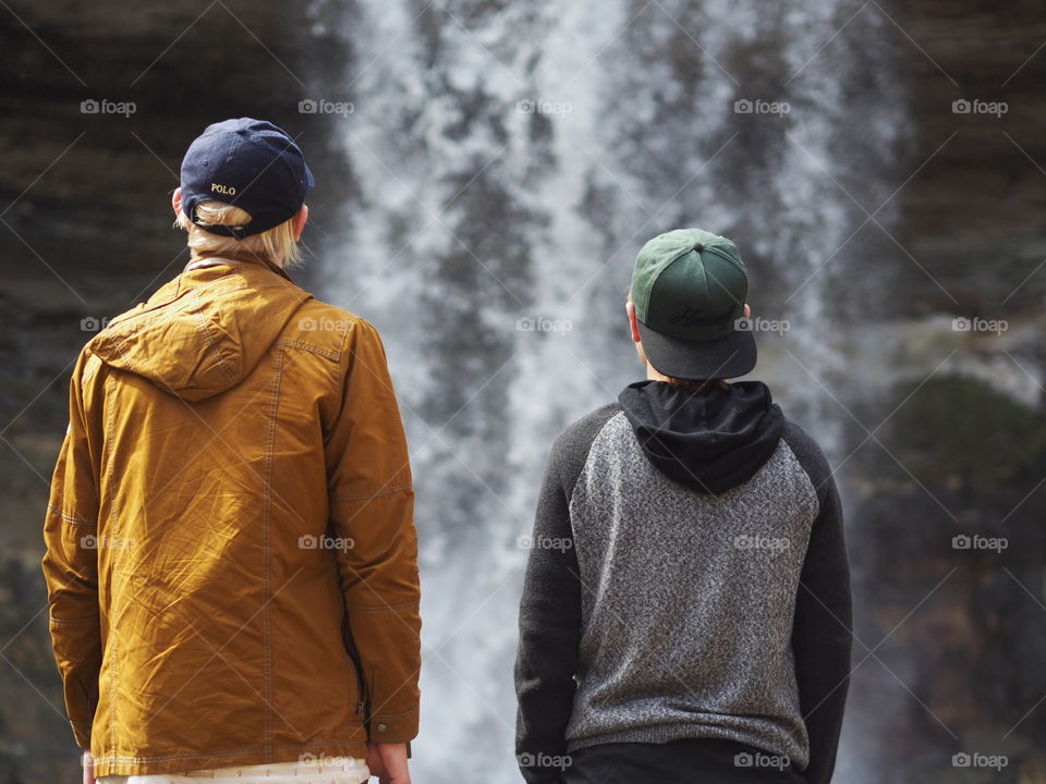 Two tourists gaze upon Minnehaha Falls.
