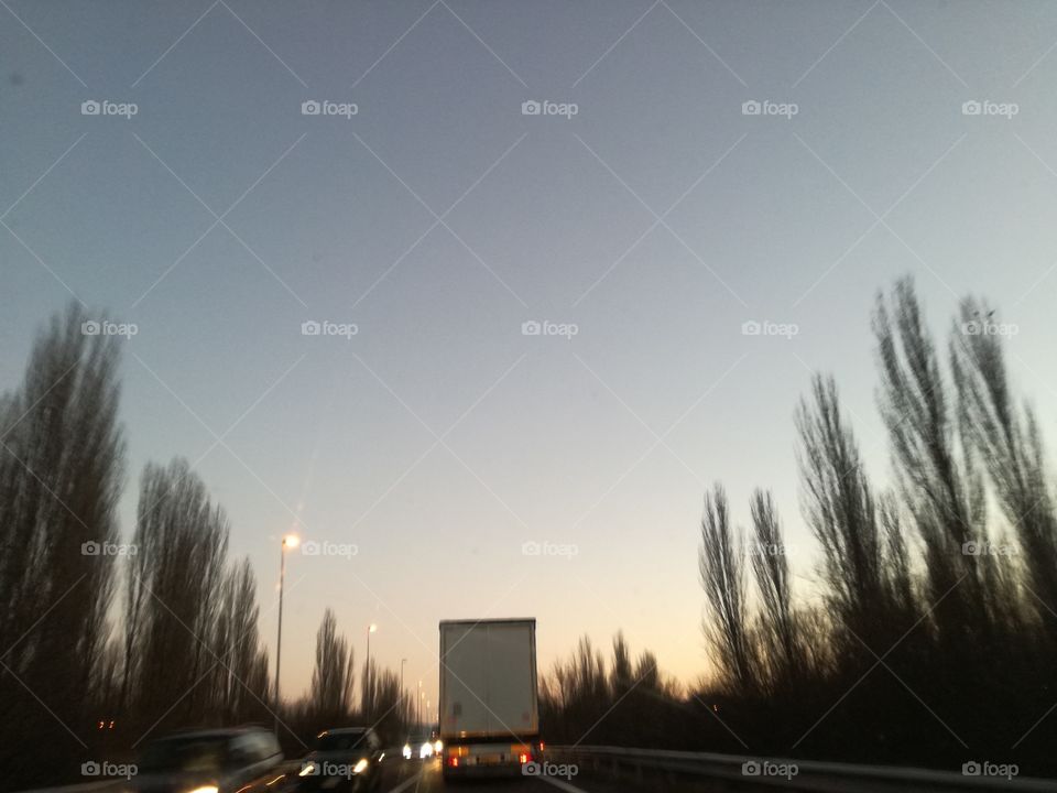 Driving sunset. Natural and artificial lights