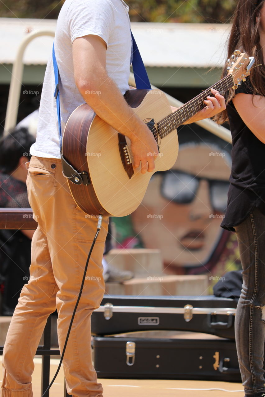 Male singer guitarist performing outdoors