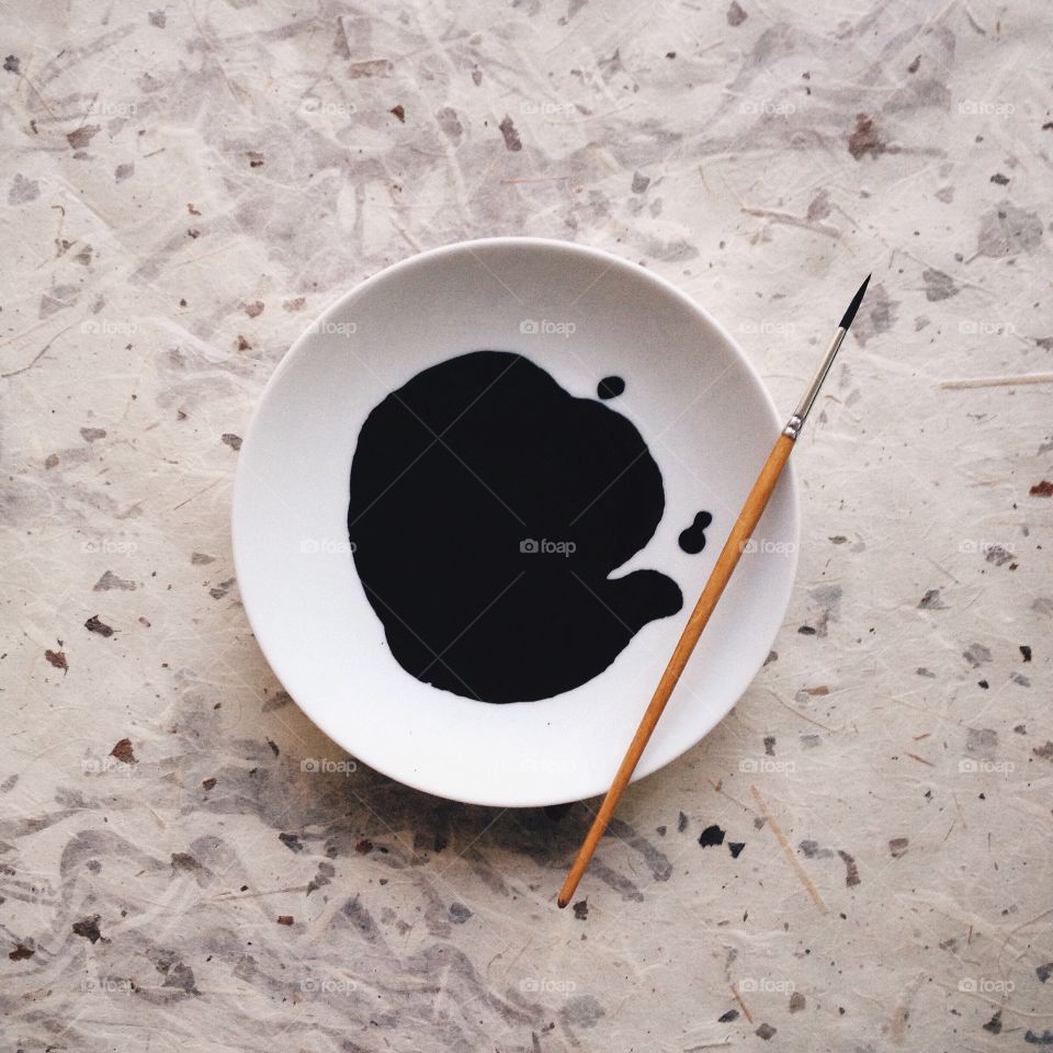 Black ink on a white plate