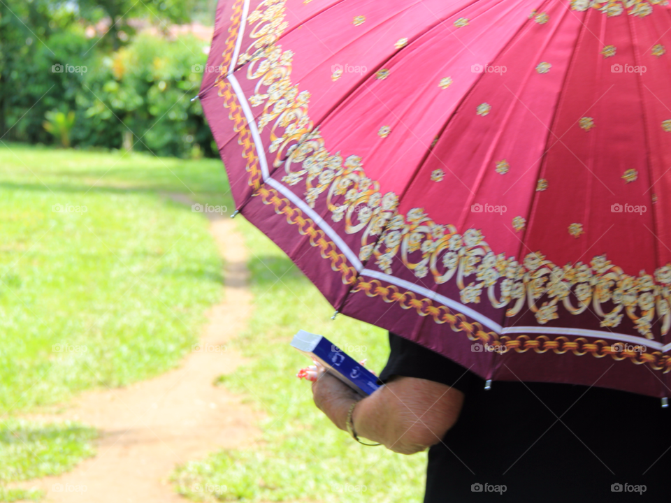 Woman, Bible and an umbrella . Taken in Costa Rica after a baptism along a river in the mountains. 