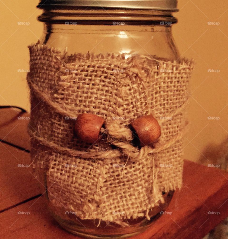 Decorated burlap and wooden bead mason jar