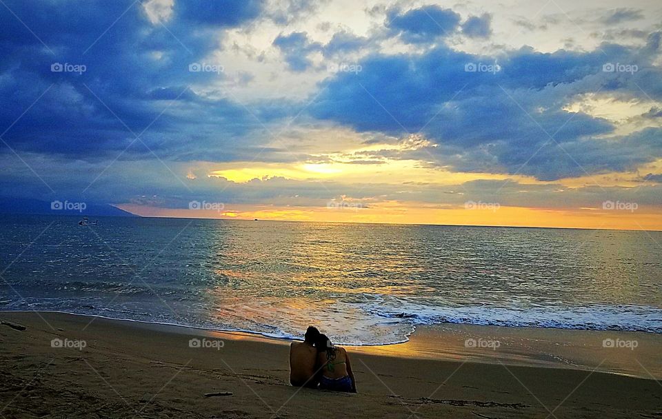couple on the beach at sunset