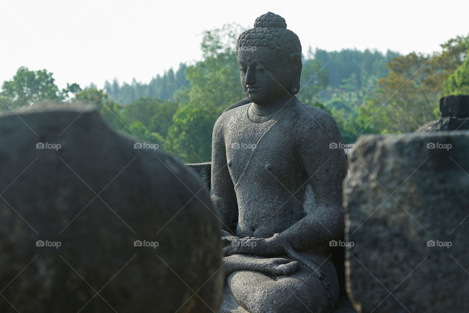 one of the buddha statues in borobudur temple
