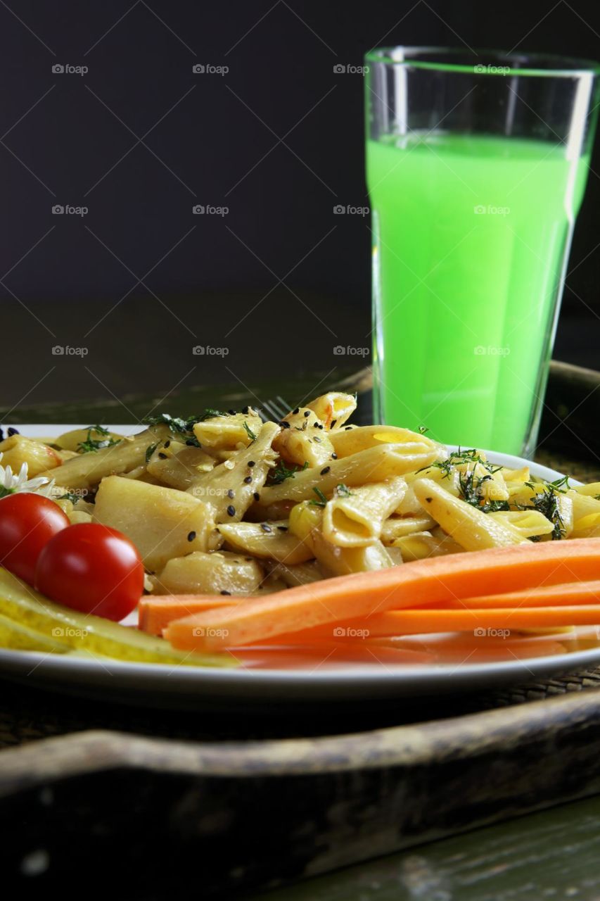 pasta on a plate and apple juice