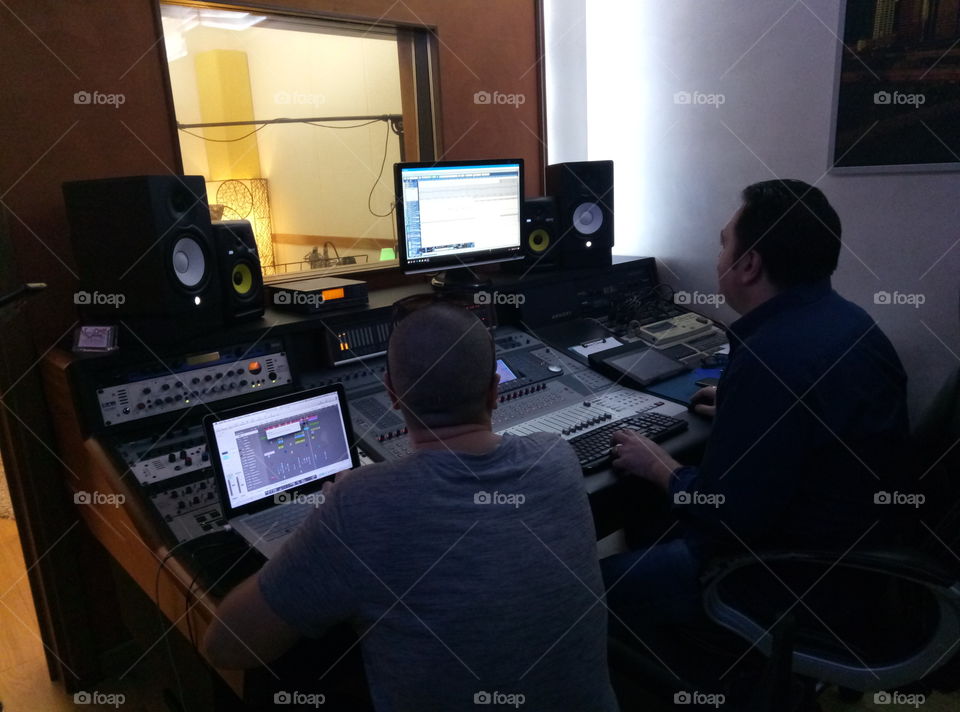 Men at work in a recording studio.