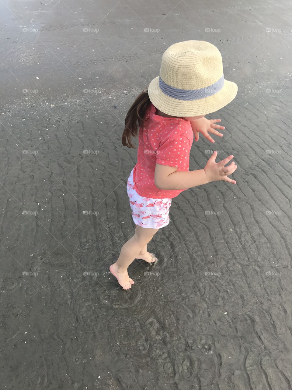 Little girl dancing in the beach