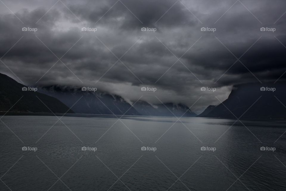 Storm clouds over mountain and lake