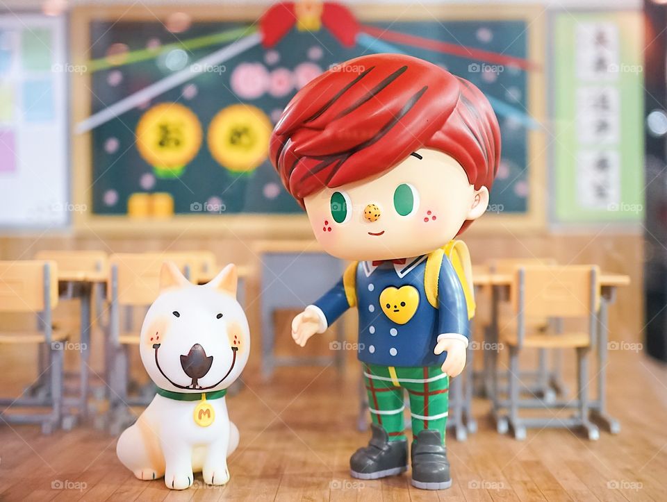 Bangkok, Thailand - May 5, 2018 : A closed up portrait of mini figure of high school student and a bull terrier dog, back to school concept. Jaime & Mimi Go To School by Yokooong. Editorial use only.