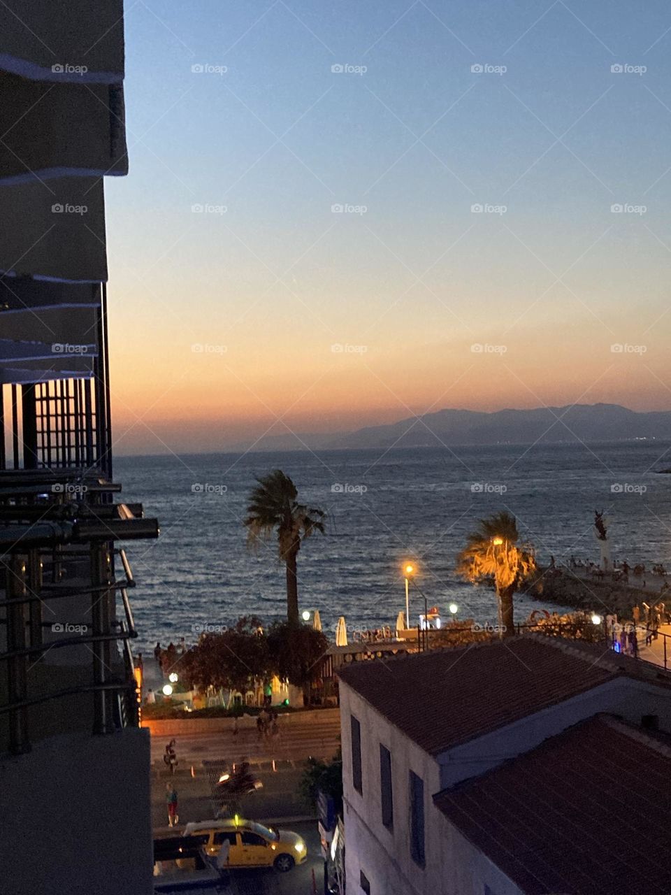 Blue sky and tall palm trees. Sunsets and sunny days. Summertime in Kusadasi. Vacation travel in Turkey . Summer view. Sunny day during vacation 