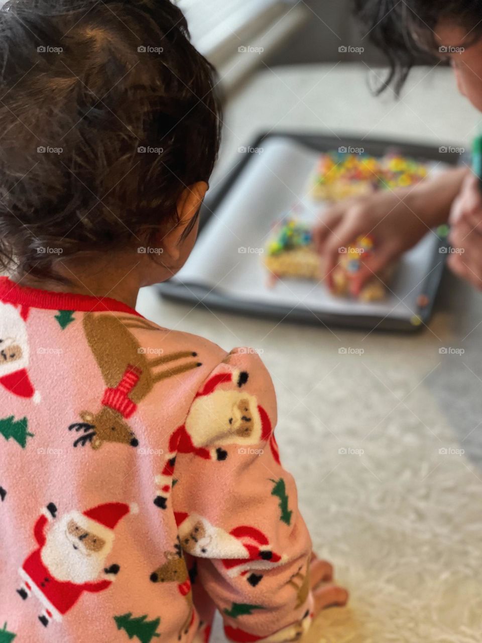 Baby watching mother preparing cookies, baby watching mama, baby and mom baking, infant and mother making cookies, toddler helps with cookies 