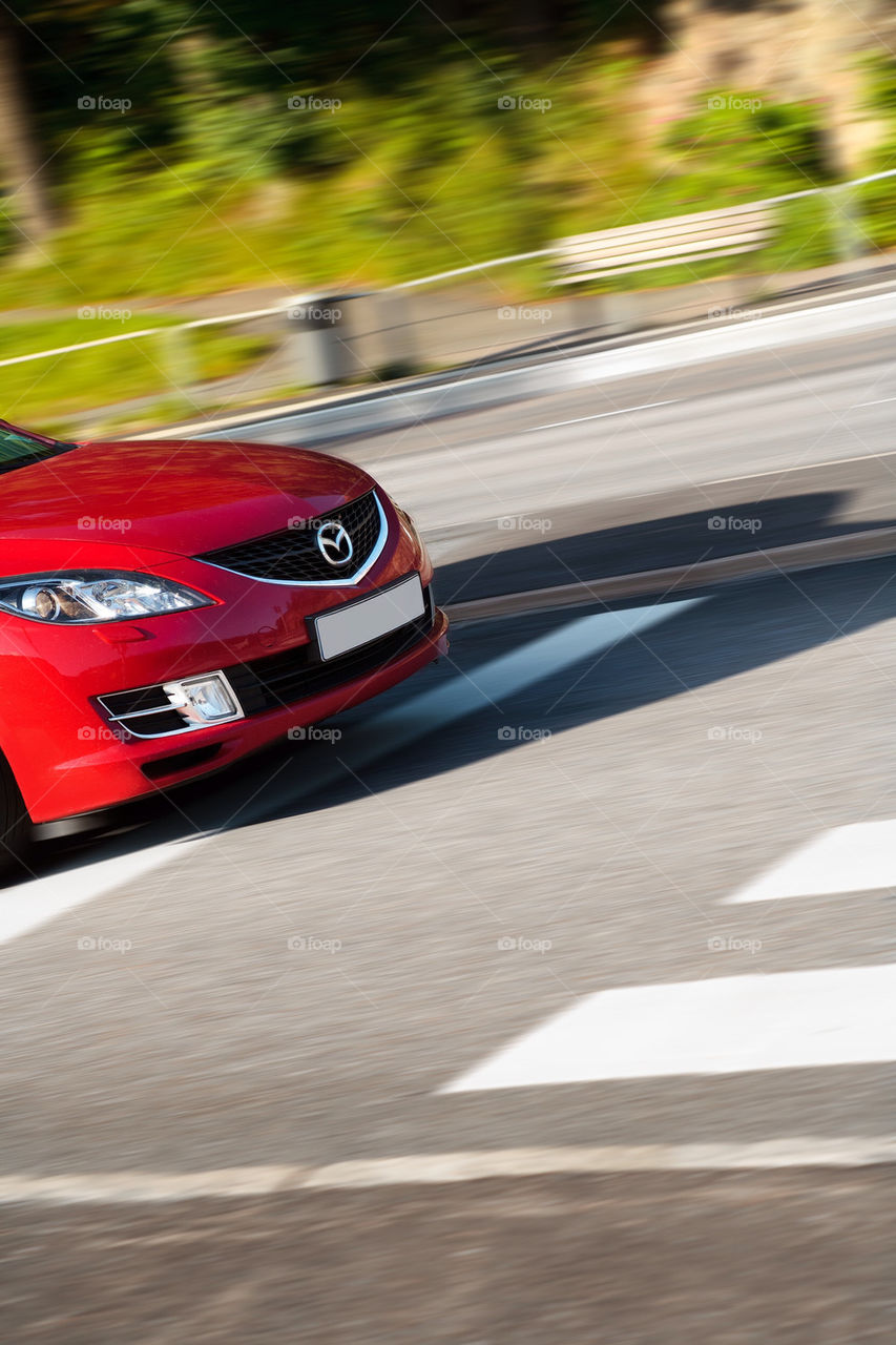 Red Mazda car in rapid movement