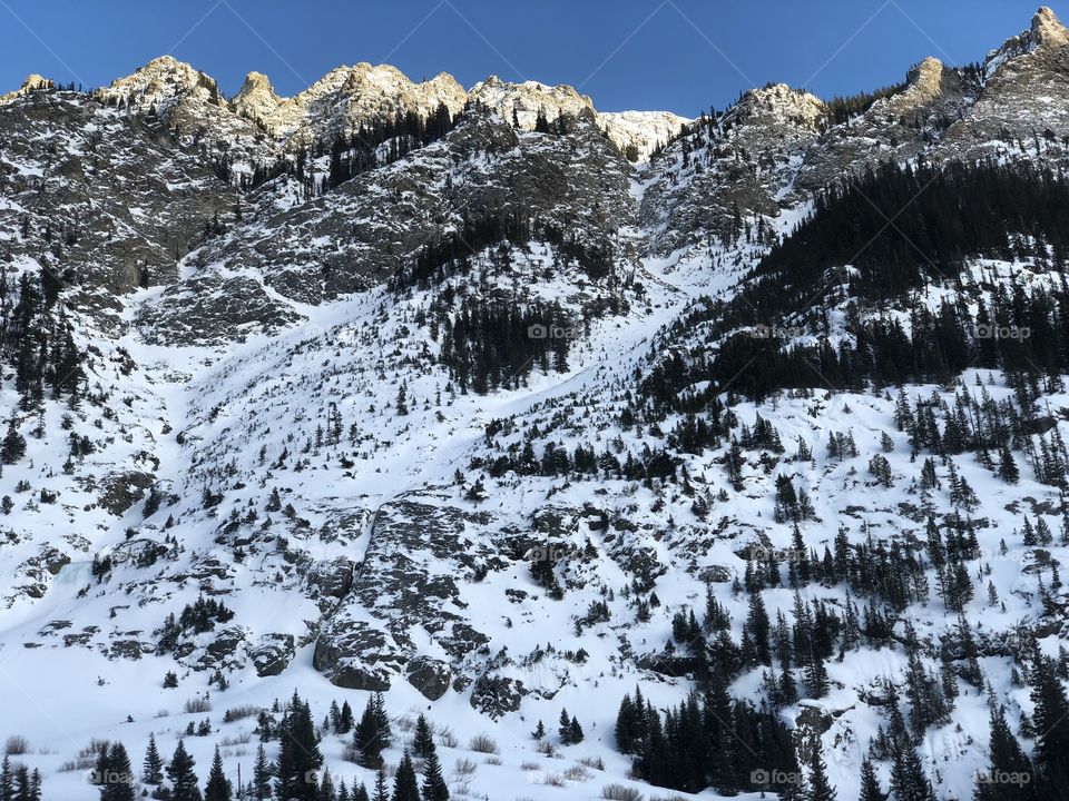 The Colorado Rockies in autumn with snow.