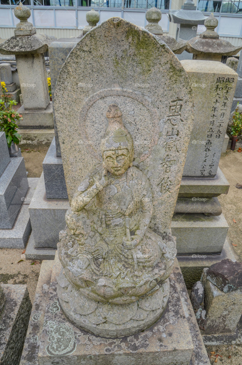 Grave With Buddha Statue At Onomichi Japan