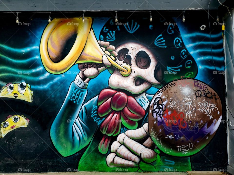 Street art celebrating Dia De Los Muertos/ Day of the Dead.  A Mexican cultural tradition of remembering and celebrating those that have passed.  The art depicts dead Mexican culture musicians.