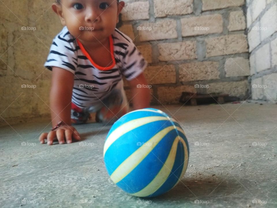 A child playing small ball