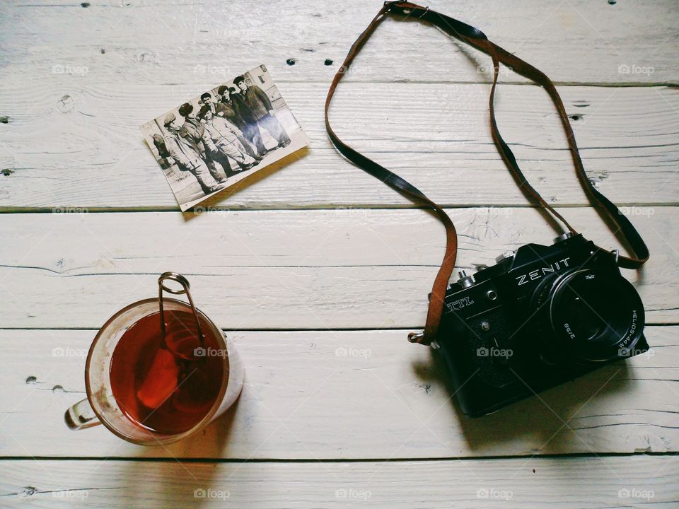 Cup of tea, old photo and old camera