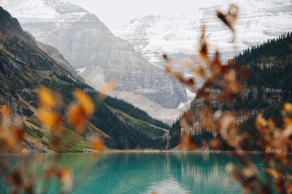 Canadian Rockies mountains in Alberta with teal blue water and snowy peaks