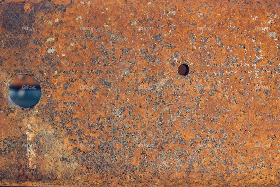 Rusted metal with holes for bolts 