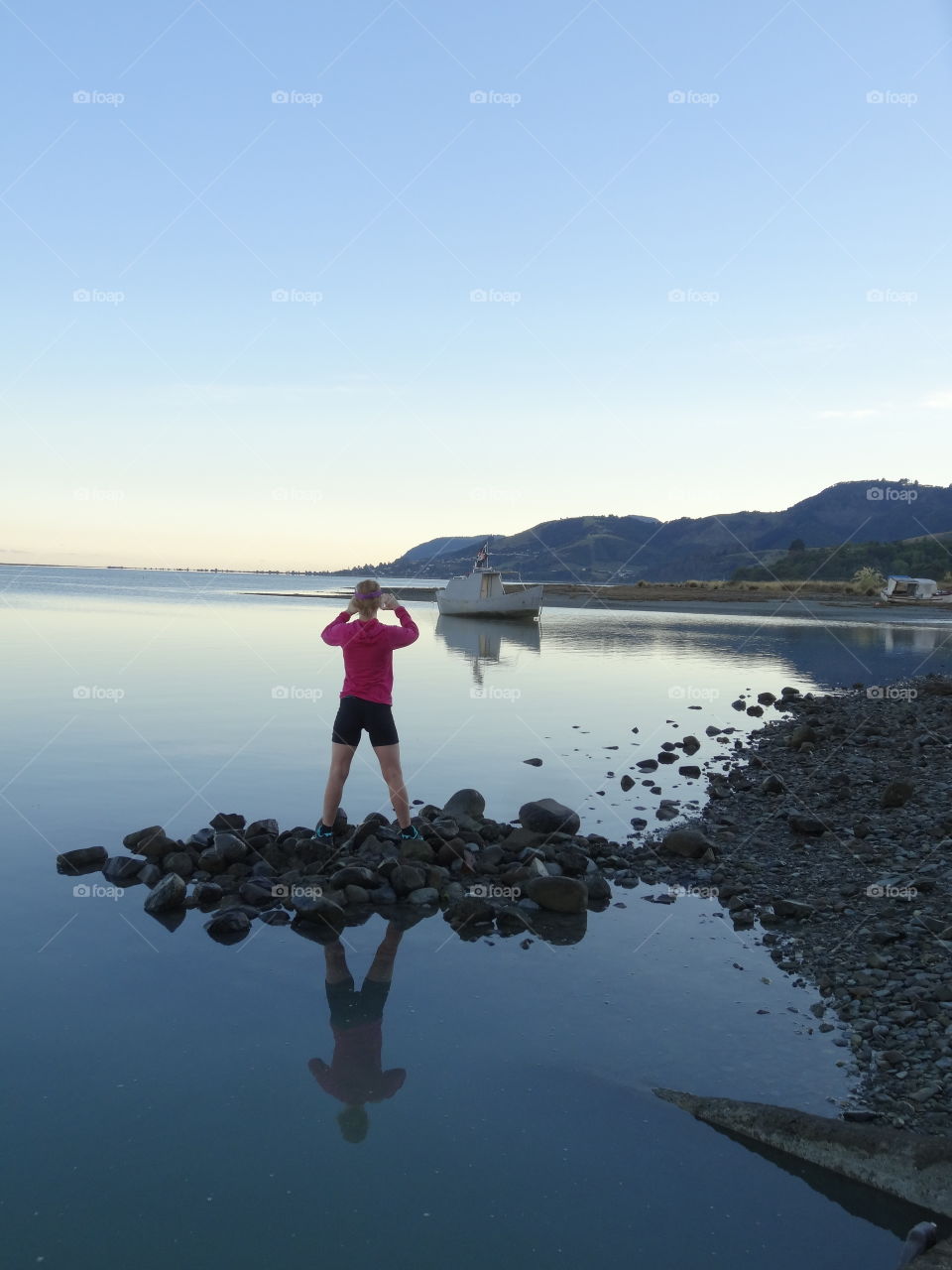 Taking a photo of the boat on the water in the early morning light 
