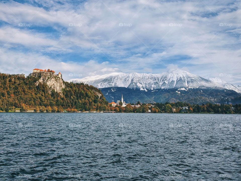 View of the snow-capped mountain peaks against the backdrop of Lake Bled.