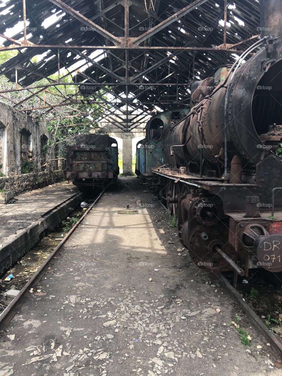 Rusty train and train station ruins 