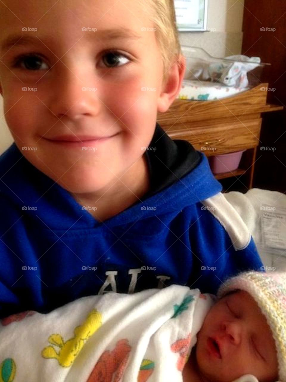 Big Brother Smile. Nothing more priceless than the proud smile of a Big Brother, while holding his baby sister.