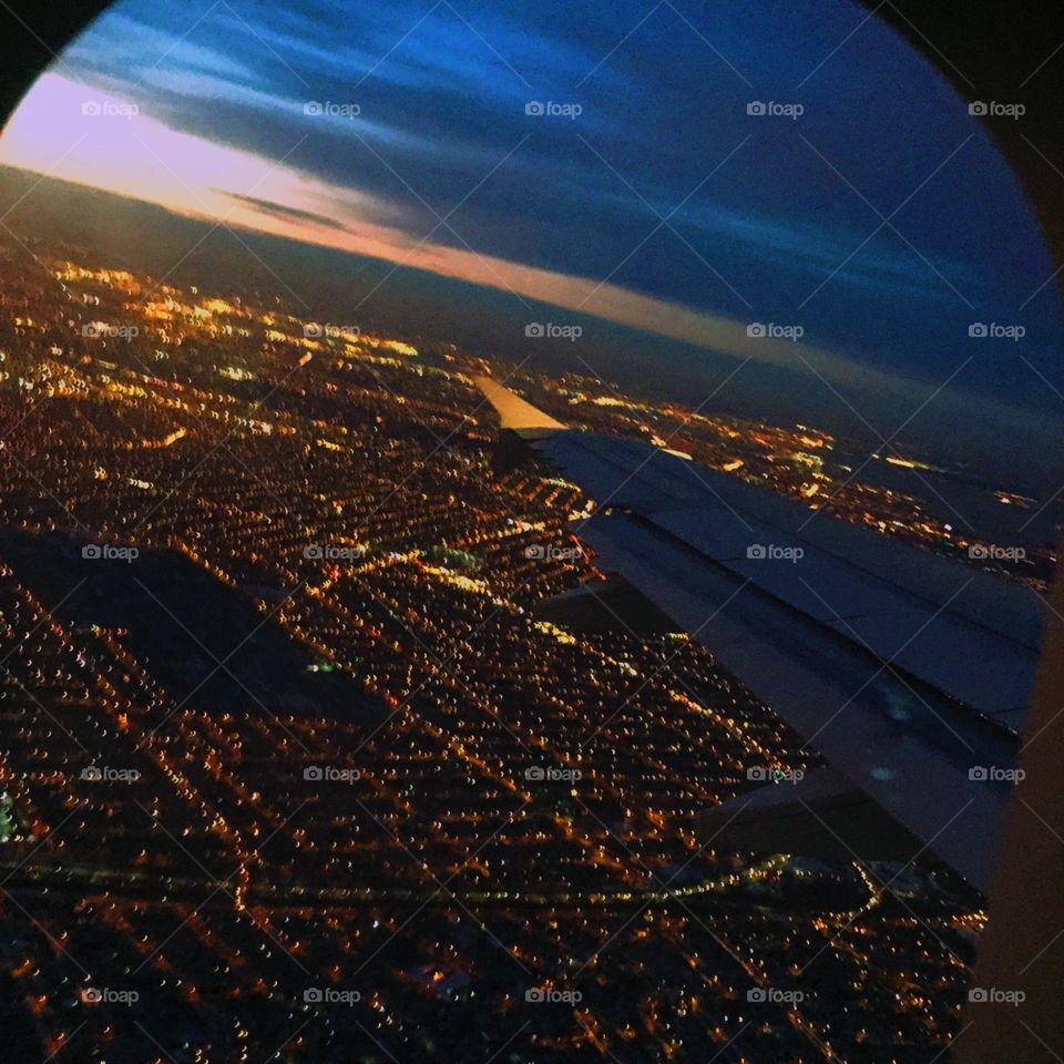 High above the clouds. New York City from above is almost as bright as from the streets. 