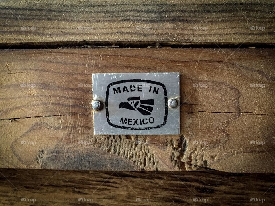 Made in Mexico plate sign in a wooden surface