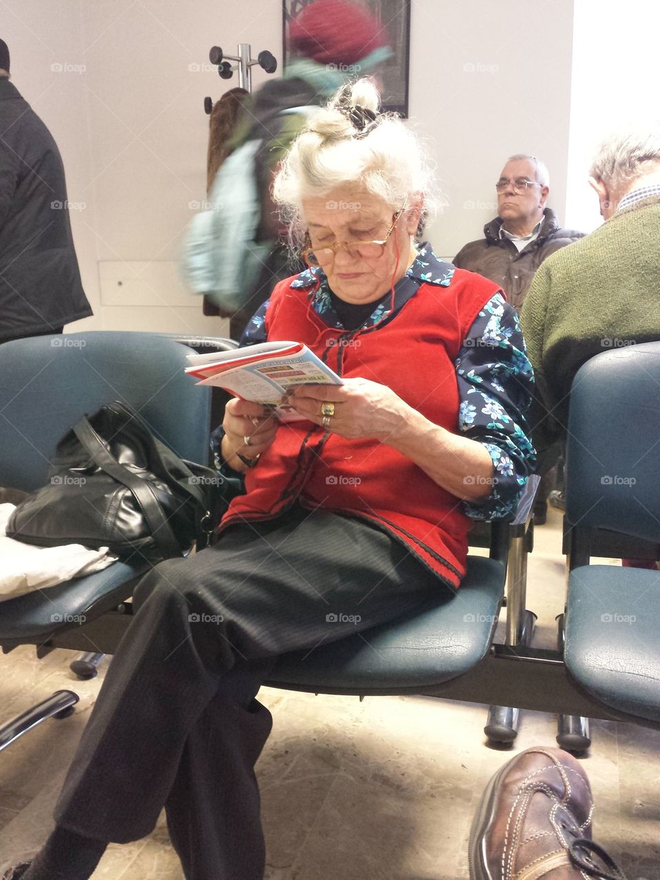 old woman waits his turn at the medical center