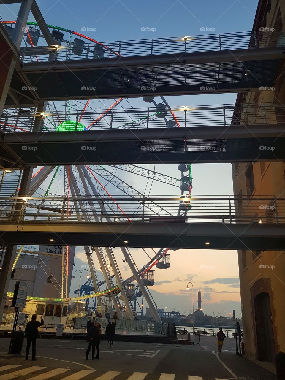 Ferris wheel in the Genoa harbor at sunset