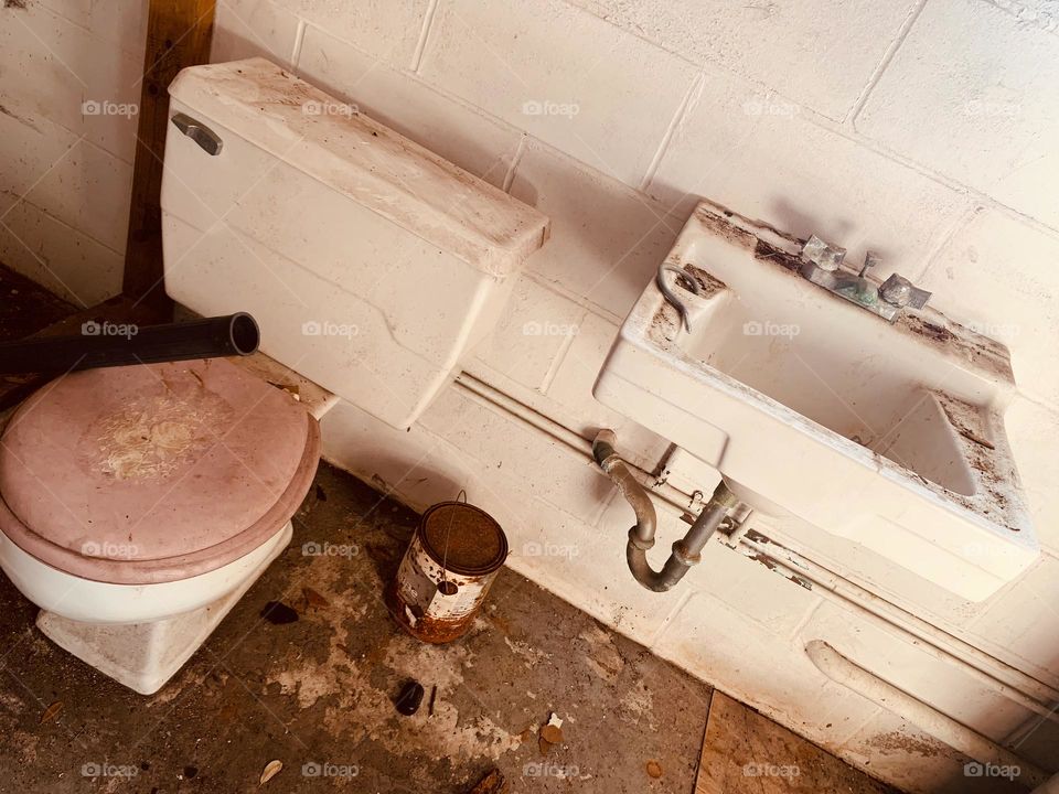 Abandoned And Needing To Be Restored Bathroom With Rusted And Destroyed Elements. 