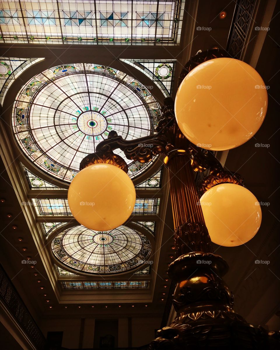Ceiling glass panels of Penn Station in Baltimore Maryland. This beautiful architecture and classic lamppost bring travelers back to the golden age of train travel.