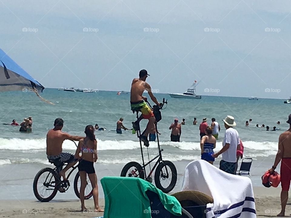 Cocoa Beach Super Boats and guy riding a crazy tall bike
