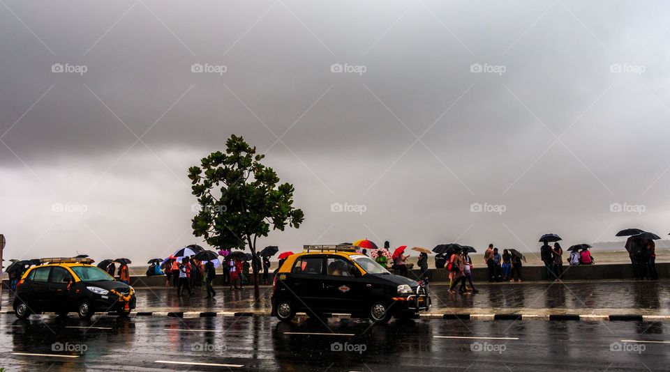 black and yellow taxi in Mumbai monsoon, India