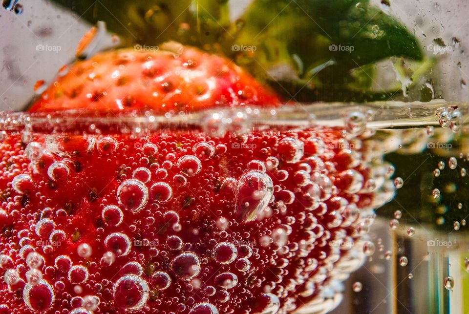 Extreme close-up of strawberry in water