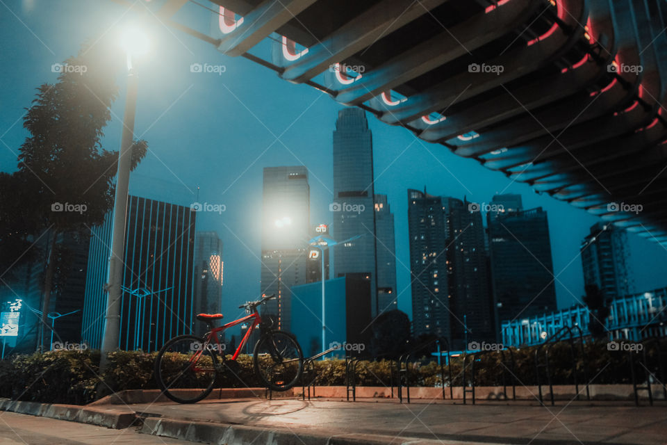 a bicycle parked under a pedestrian bridge