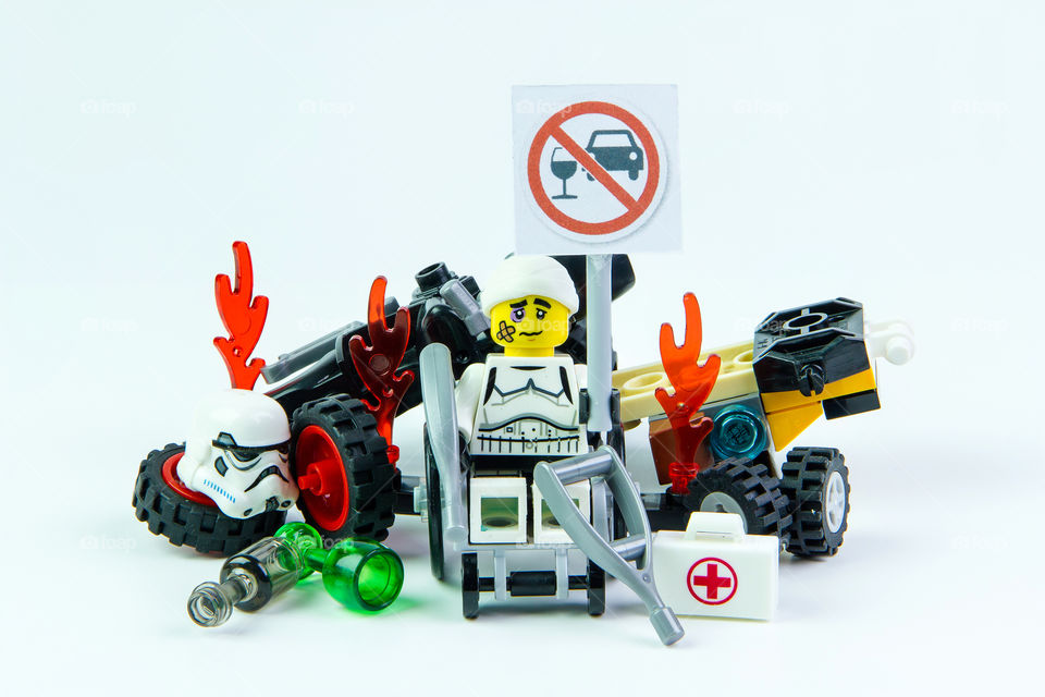 Nonthabure, Thailand - August, 08, 2016 : Lego star wars accident by a drunk driver. holding a sign Drink don't drive isolated on white background.Lego is an interlocking brick system collected around the world.