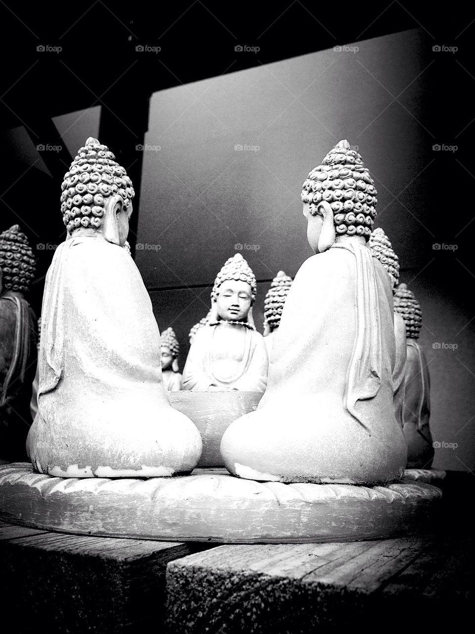 Buddha figures meditating in a enso circle 
