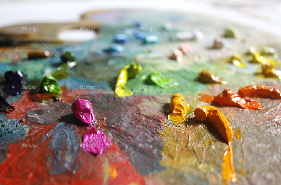 Oil paint on colorful palette, macro, close up