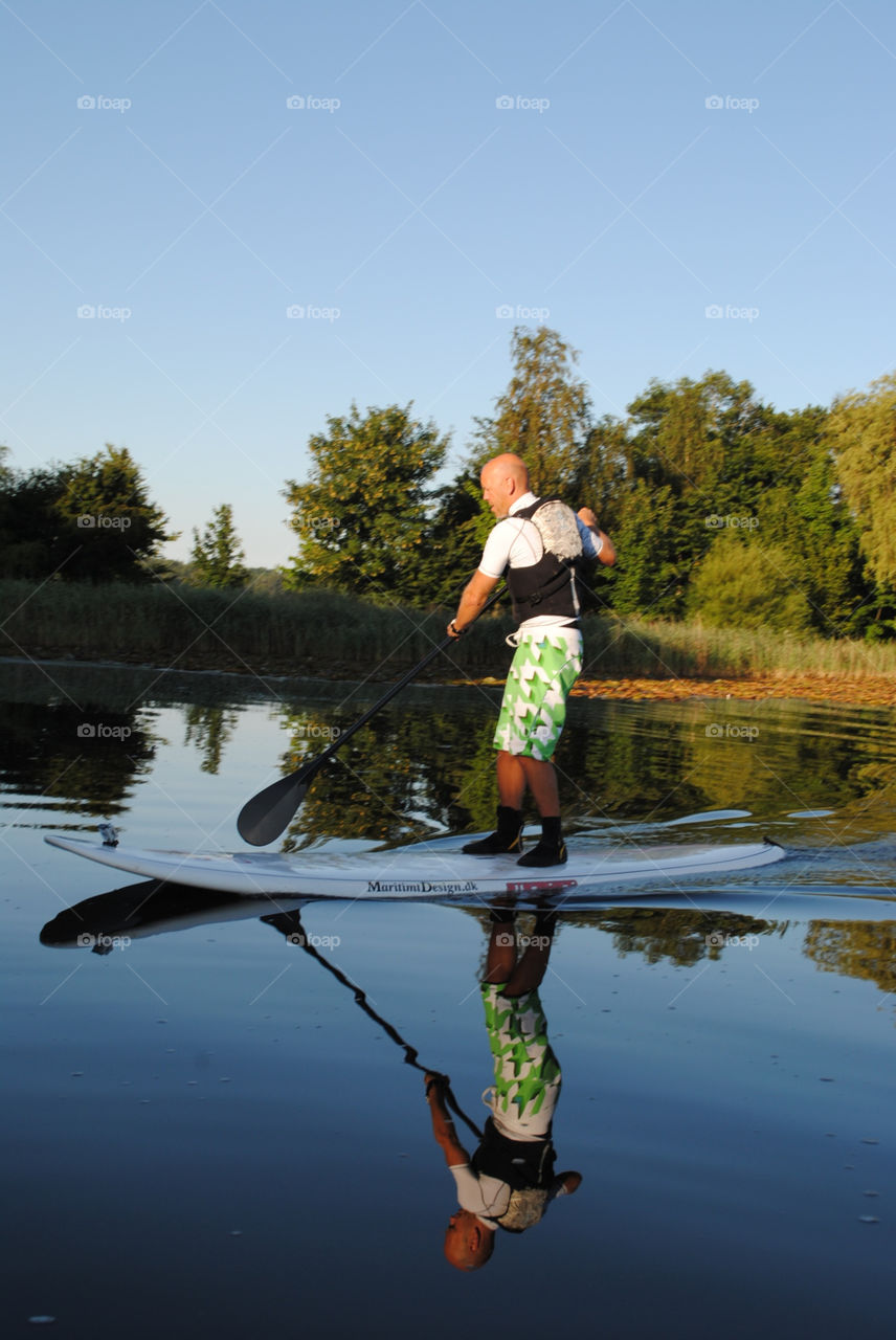 man reflection sup water by salsa