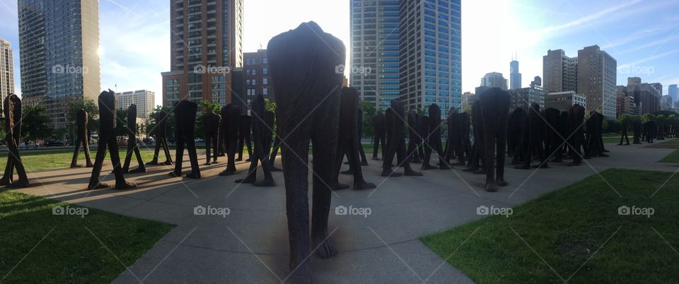 Statue of a Crowd of People Walking in all Directions with no Heads Attached