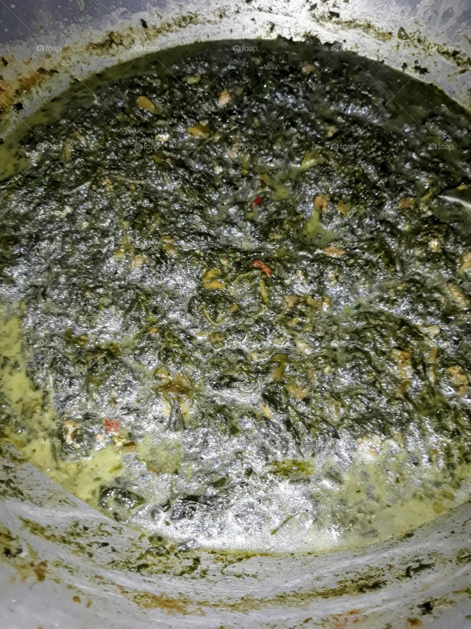 Cooking Laing, a Filipino hot and spicy dish made of dried taro leaves cooked in coconut milk.