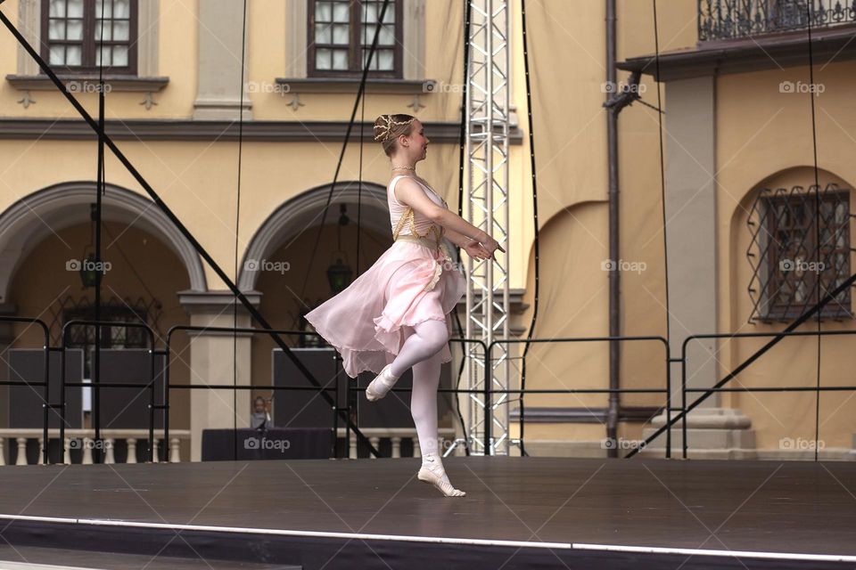 Young ballerina on an open-air stage, summer, dance, freedom