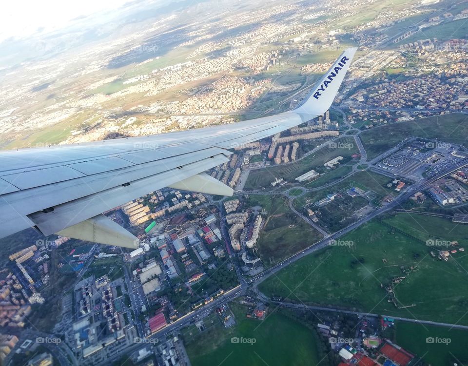 Wing of the plane and landscape seen from above