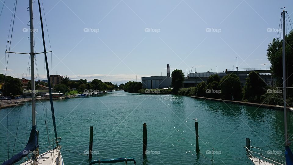 Italian marina in summer with  boats and river channel