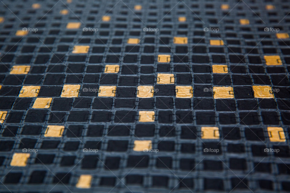 Textured gold and black square paper close up. Shapes squares and rectangle