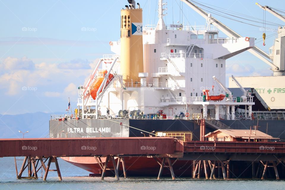 Cargo ship at loading dock of Australian steel iron ore mill