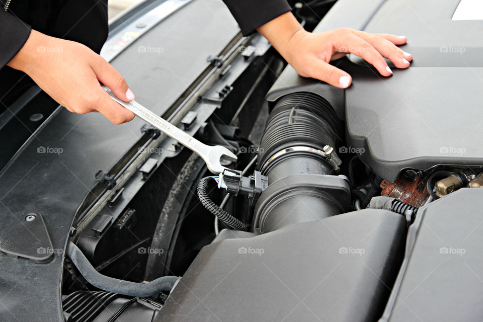 Girl fixing the car